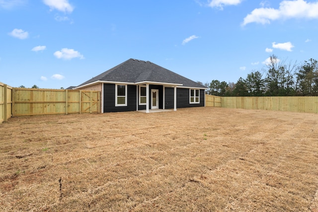 back of house featuring a yard