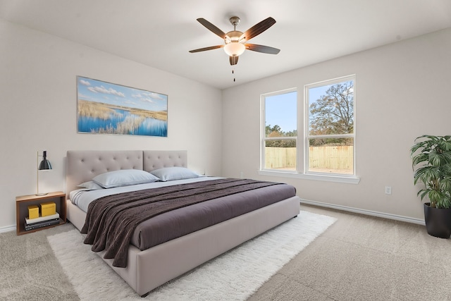 bedroom featuring light carpet and ceiling fan