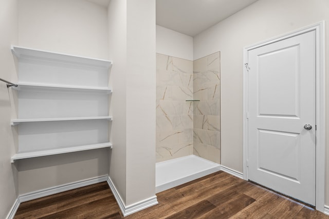 bathroom featuring wood-type flooring and walk in shower