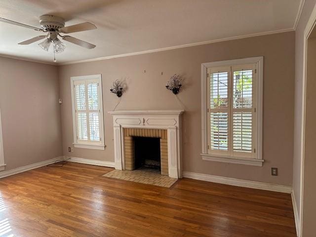 unfurnished living room with ceiling fan, wood-type flooring, a fireplace, and ornamental molding