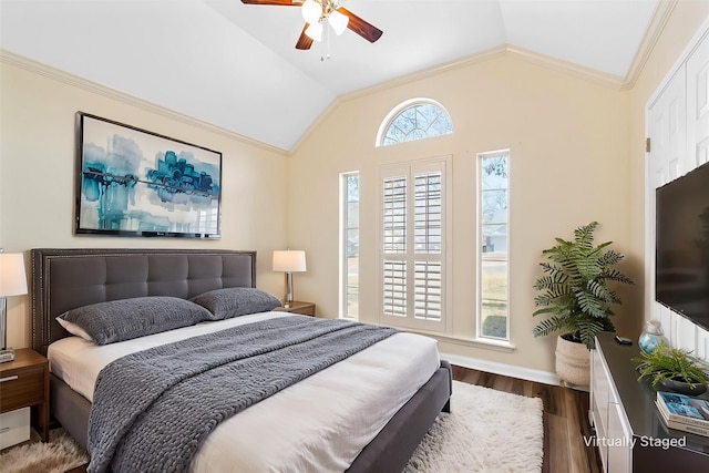 bedroom featuring lofted ceiling, dark wood-type flooring, ornamental molding, and ceiling fan