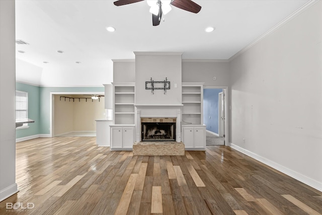 unfurnished living room featuring crown molding, ceiling fan, and hardwood / wood-style floors