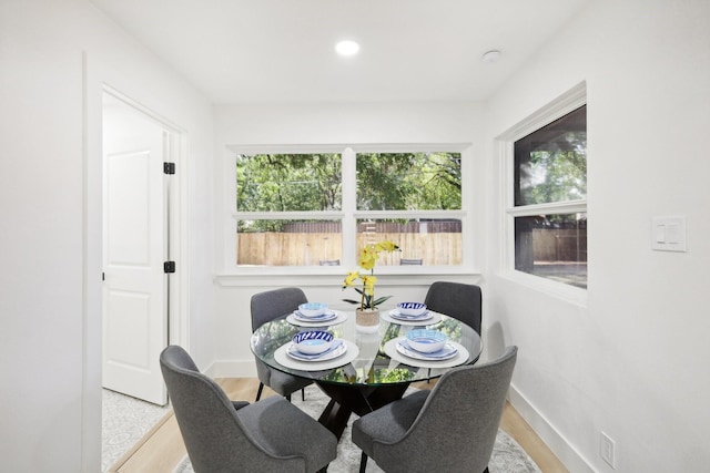 dining space with wood-type flooring