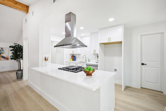 kitchen featuring island range hood, stainless steel appliances, decorative backsplash, beam ceiling, and white cabinets