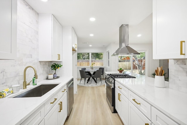 kitchen featuring sink, white cabinets, island range hood, and stainless steel appliances