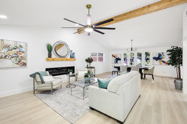 living room with ceiling fan, vaulted ceiling with beams, and light wood-type flooring