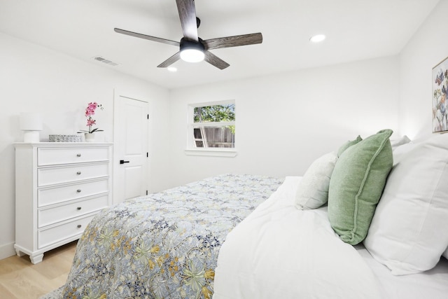 bedroom with ceiling fan and light hardwood / wood-style flooring