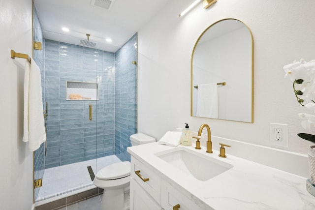 bathroom with vanity, toilet, tile patterned flooring, and walk in shower