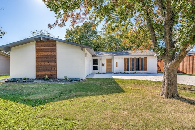 rear view of property featuring a yard