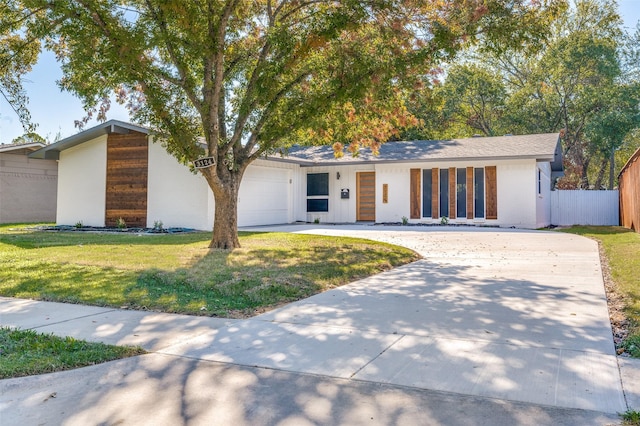 single story home with a front yard and a garage