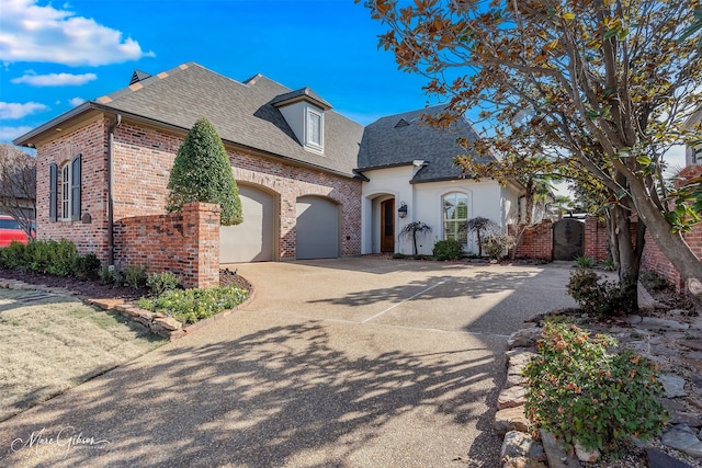 french country inspired facade featuring a garage