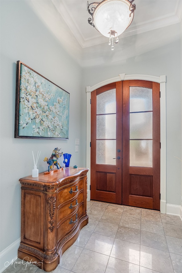 tiled foyer featuring ornamental molding and french doors