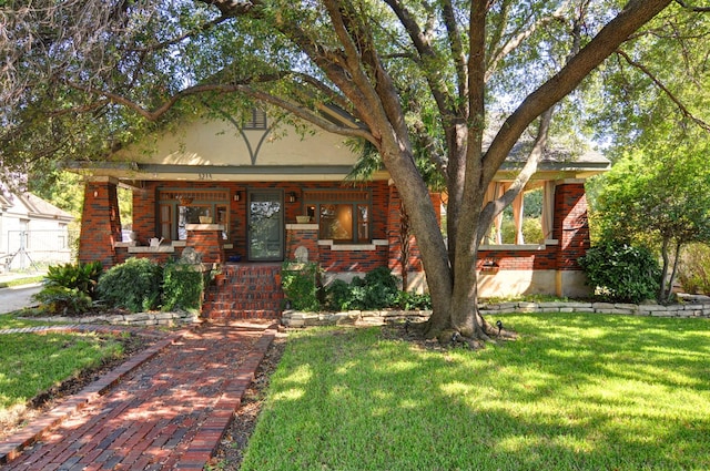 view of front of house featuring a front lawn and covered porch