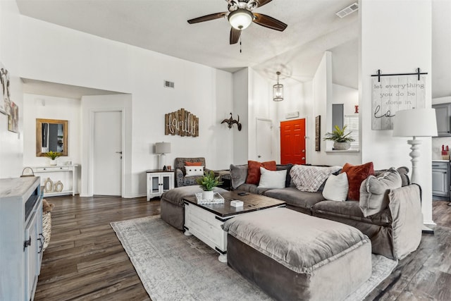 living room featuring dark wood-type flooring, lofted ceiling, and ceiling fan