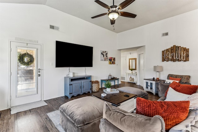 living room with ceiling fan, vaulted ceiling, and dark hardwood / wood-style flooring