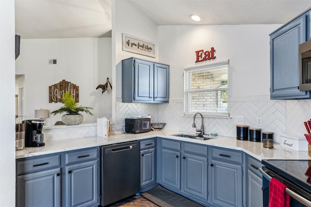 kitchen featuring tasteful backsplash, dishwasher, sink, and blue cabinets