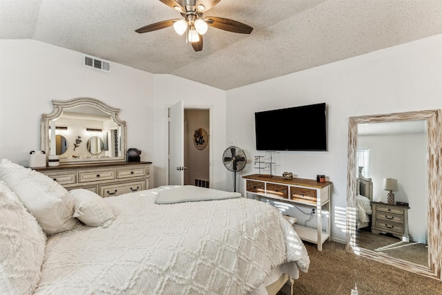 carpeted bedroom featuring lofted ceiling, ceiling fan, and a textured ceiling