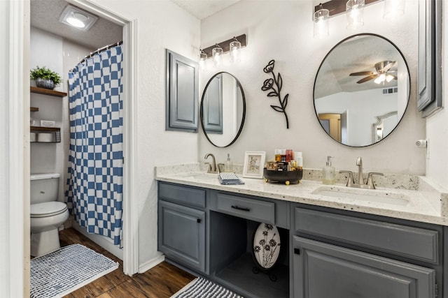 bathroom with toilet, ceiling fan, hardwood / wood-style floors, and vanity