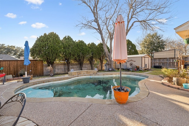 view of pool featuring a patio and a storage unit