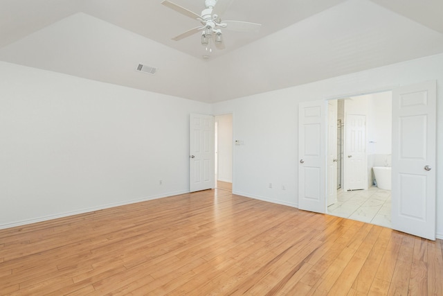 unfurnished bedroom featuring ceiling fan, light hardwood / wood-style floors, and connected bathroom