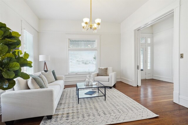 living room featuring dark hardwood / wood-style floors and a notable chandelier