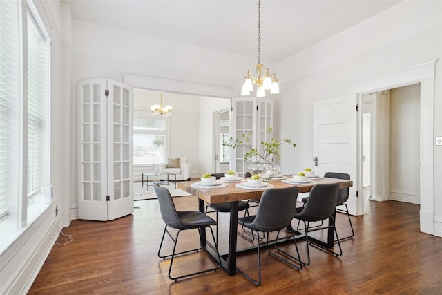 dining room with an inviting chandelier and dark hardwood / wood-style floors