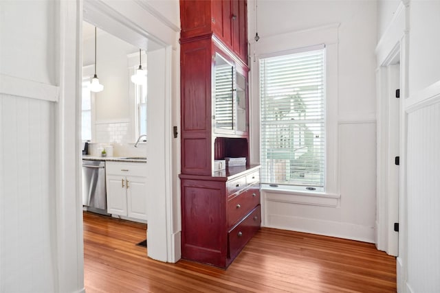 hall featuring hardwood / wood-style flooring and sink