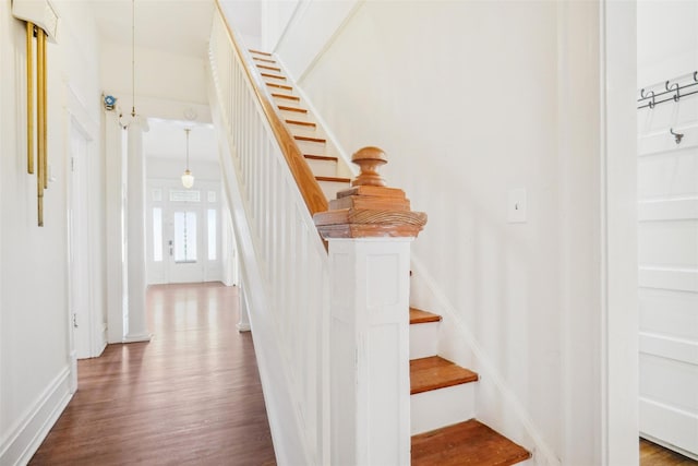 stairs featuring hardwood / wood-style floors