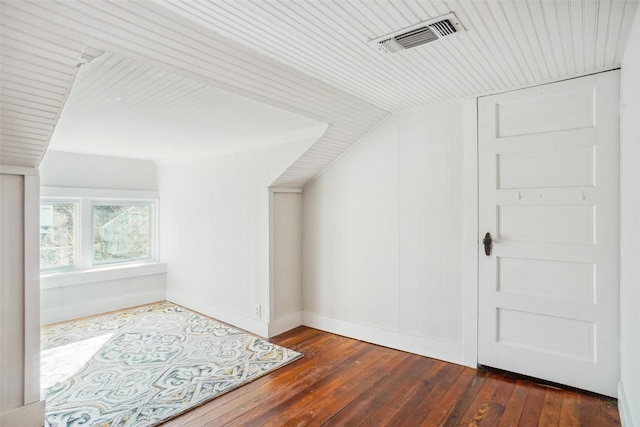 bonus room with dark wood-type flooring and lofted ceiling