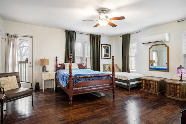 bedroom featuring ceiling fan, dark hardwood / wood-style flooring, access to exterior, and a wall unit AC