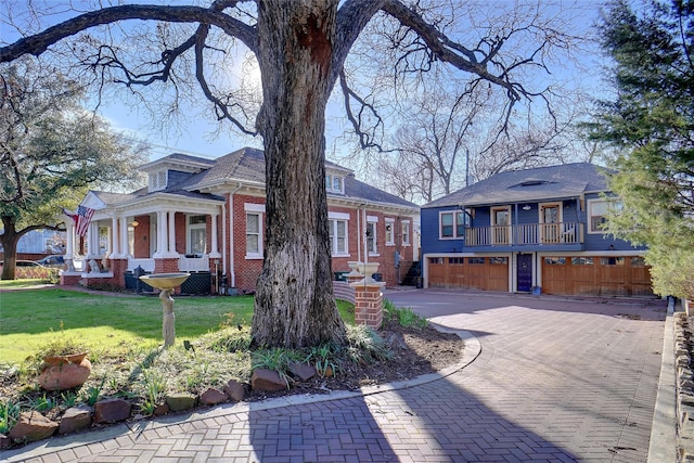 view of front of home featuring a garage and a balcony