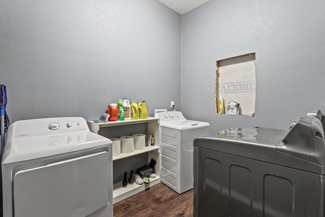 clothes washing area featuring dark wood-type flooring and separate washer and dryer