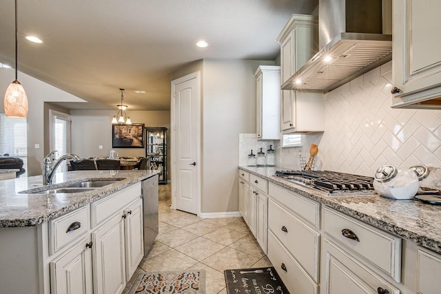 kitchen featuring pendant lighting, sink, white cabinetry, light tile patterned floors, and wall chimney exhaust hood