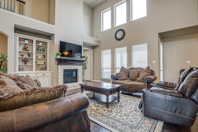 living room featuring a fireplace and a towering ceiling