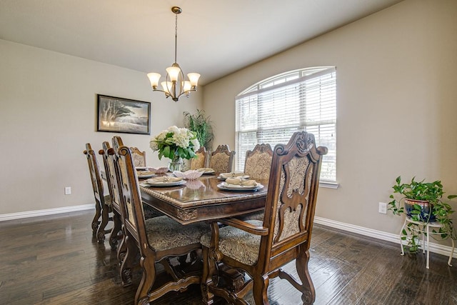 dining space featuring a wealth of natural light, a chandelier, and dark hardwood / wood-style flooring