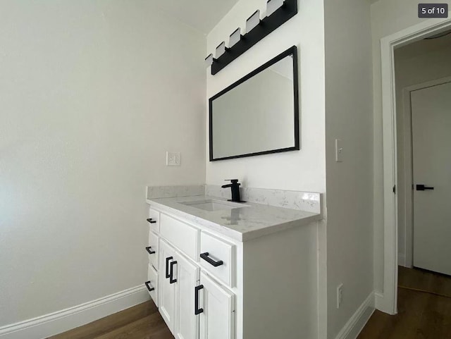 bathroom featuring hardwood / wood-style flooring and vanity