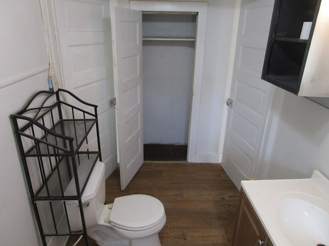 bathroom featuring hardwood / wood-style floors, toilet, and vanity