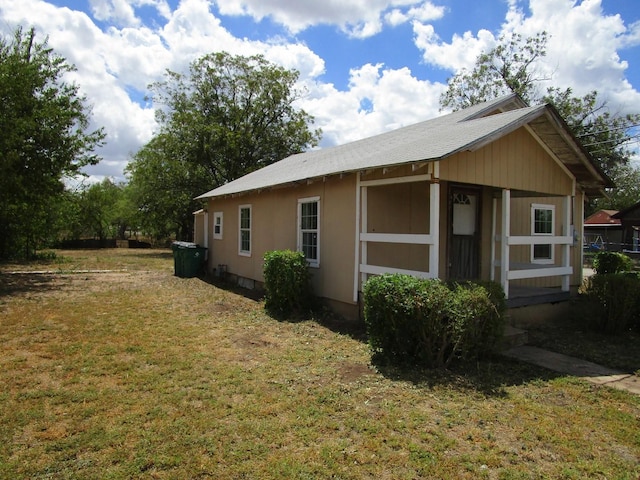 view of side of home featuring a yard