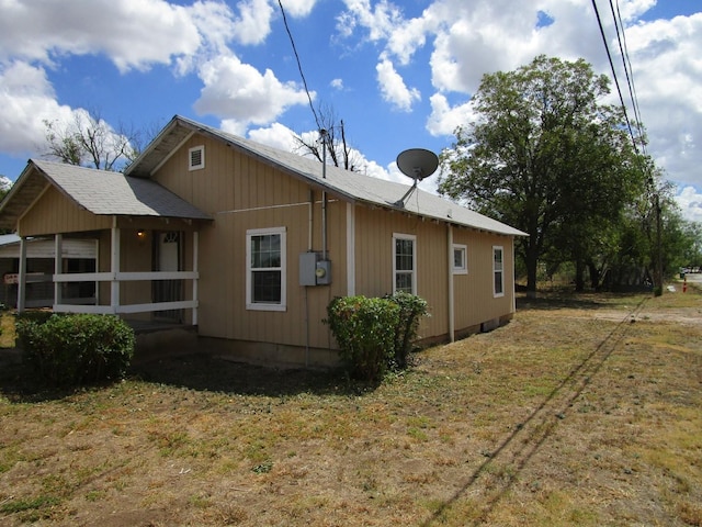 view of property exterior with a lawn