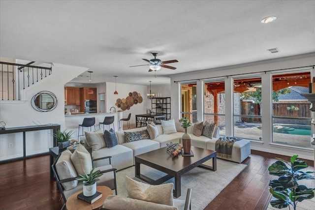 living room with ceiling fan, dark hardwood / wood-style flooring, and ornamental molding