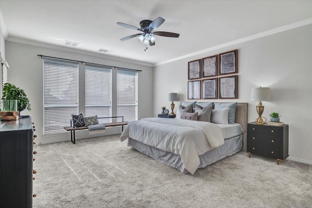 bedroom featuring ceiling fan, crown molding, and light colored carpet