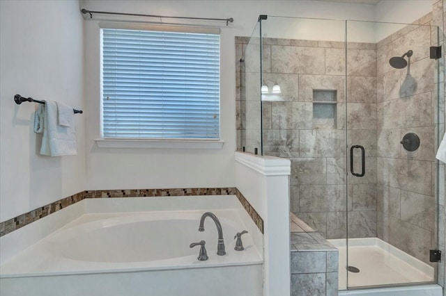 bathroom featuring separate shower and tub