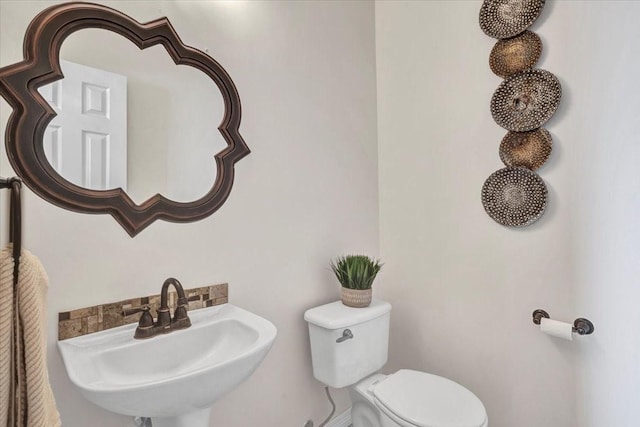 bathroom featuring toilet and sink