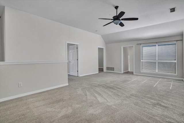 empty room with vaulted ceiling, ceiling fan, and light carpet