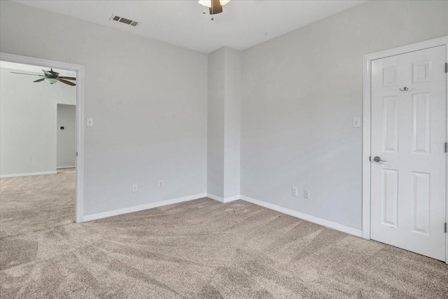 carpeted empty room featuring ceiling fan