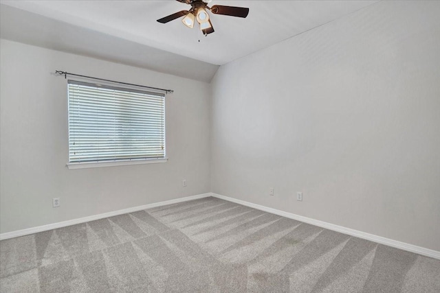 spare room featuring carpet, ceiling fan, and lofted ceiling