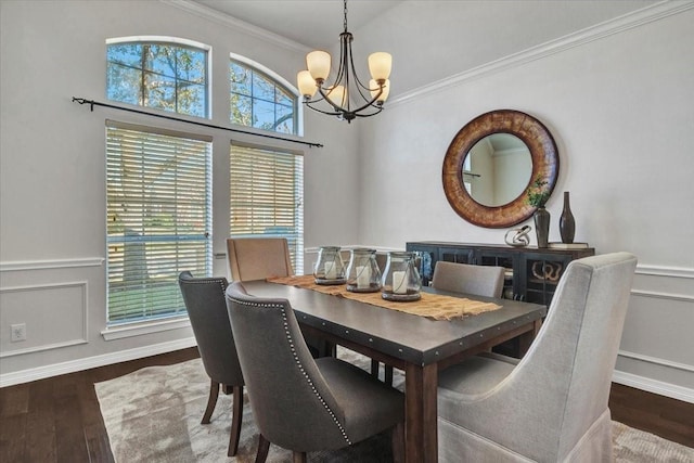 dining area with a wealth of natural light, a notable chandelier, dark hardwood / wood-style flooring, and crown molding