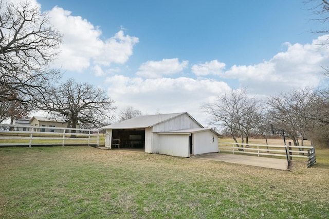 view of outdoor structure with a rural view and a lawn