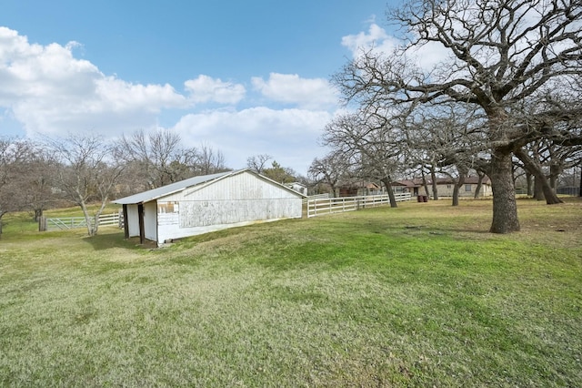 view of yard featuring a rural view and an outdoor structure