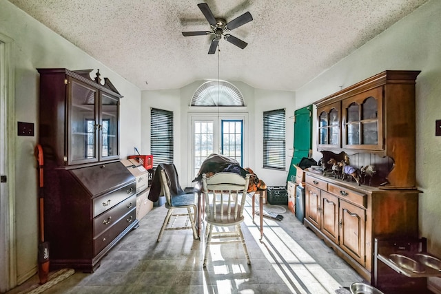 interior space with lofted ceiling, ceiling fan, and french doors